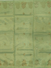 Load image into Gallery viewer, Desingers tissue saree with floral patterns all over and tasselled pallu and blouse.