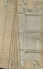 Load image into Gallery viewer, Desingers tissue saree with floral patterns all over and tasselled pallu and blouse.

