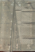 Load image into Gallery viewer, Desingers tissue saree with floral patterns all over and tasselled pallu and blouse.

