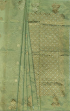 Load image into Gallery viewer, Desingers tissue saree with floral patterns all over and tasselled pallu and blouse.
