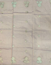 Load image into Gallery viewer, Desingers tissue saree with floral patterns all over and tasselled pallu and blouse.
